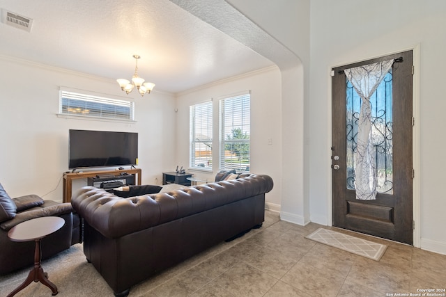 tiled living room featuring a chandelier, a textured ceiling, and crown molding