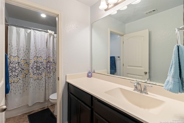 bathroom featuring tile patterned floors, vanity, and toilet