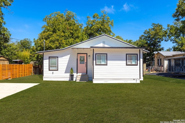 bungalow-style house featuring a front yard