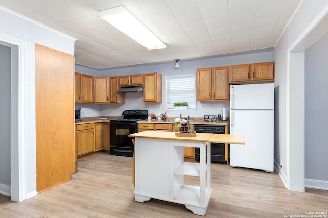 kitchen with ornamental molding, light wood-type flooring, and black appliances