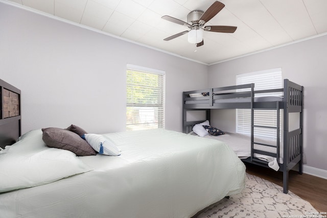 bedroom with ornamental molding, ceiling fan, and light hardwood / wood-style floors