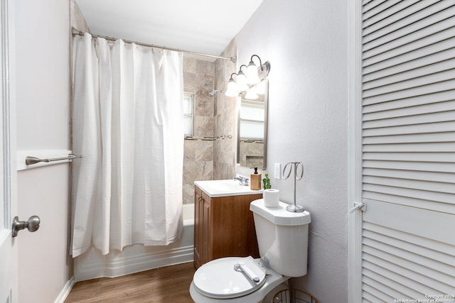 full bathroom with toilet, wood-type flooring, vanity, and shower / tub combo