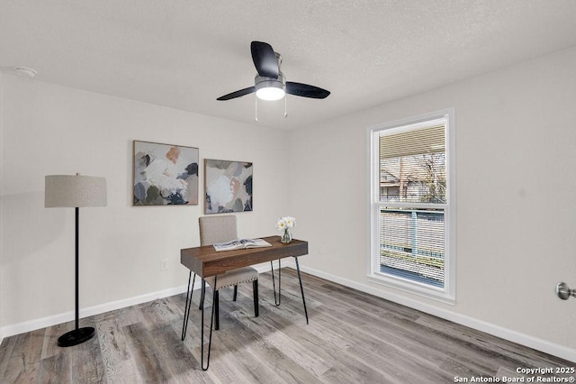 office space with ceiling fan and hardwood / wood-style flooring