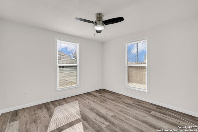 spare room featuring hardwood / wood-style flooring and ceiling fan