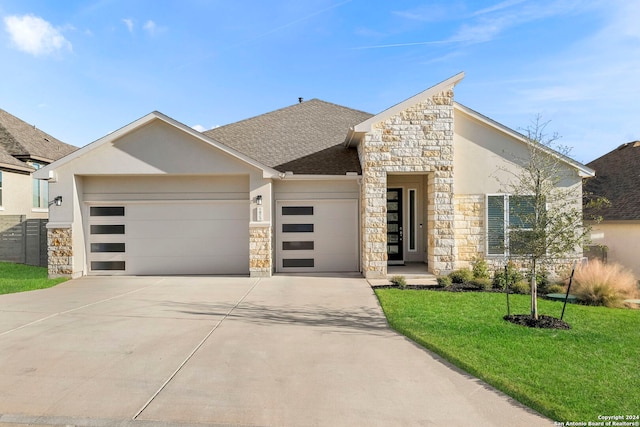 view of front facade with a garage and a front yard