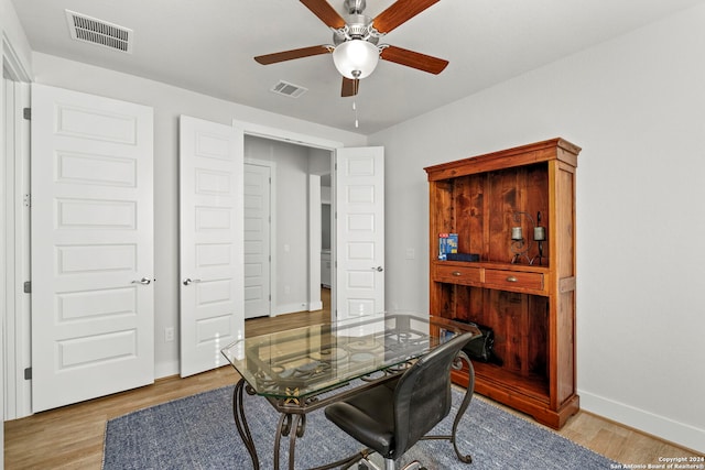 office space featuring light hardwood / wood-style flooring and ceiling fan