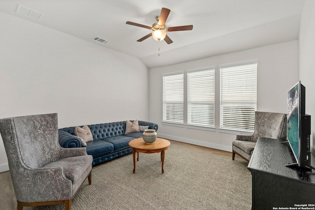 living room featuring hardwood / wood-style flooring, lofted ceiling, and ceiling fan