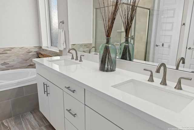 bathroom with independent shower and bath and vanity