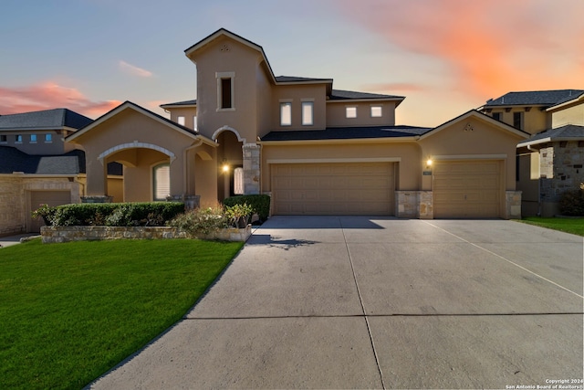 view of front facade with a garage and a yard