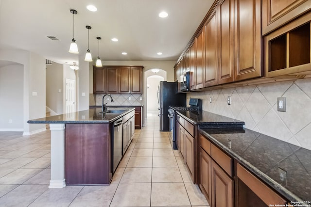 kitchen with stainless steel appliances, light tile patterned floors, sink, and tasteful backsplash