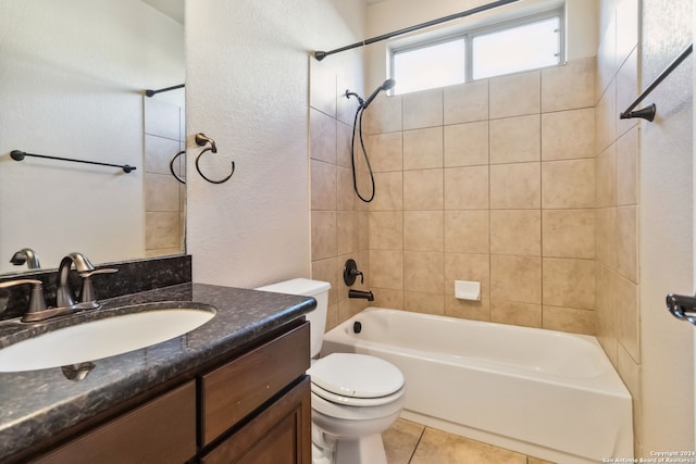 full bathroom with tile patterned flooring, tiled shower / bath, toilet, and vanity