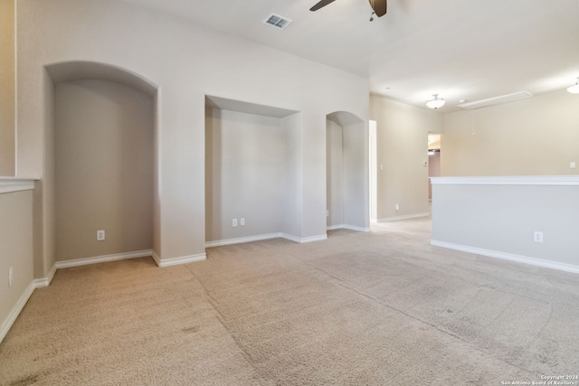 spare room featuring ceiling fan and light colored carpet