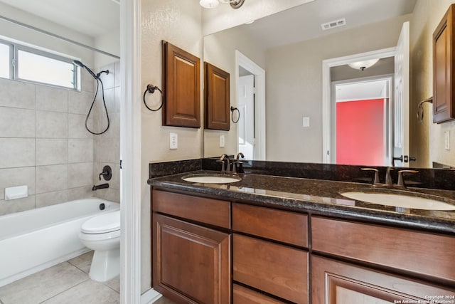 full bathroom with vanity, tile patterned floors, toilet, and tiled shower / bath combo