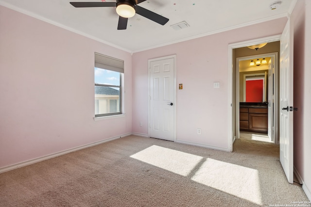 unfurnished bedroom featuring light carpet, ceiling fan, and crown molding