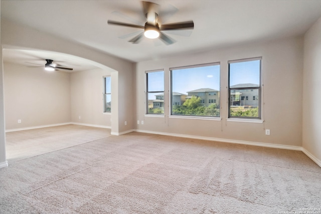 carpeted spare room with ceiling fan