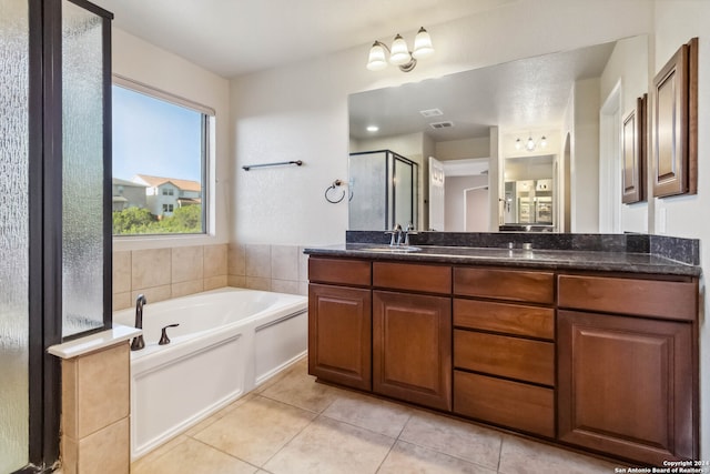 bathroom featuring tile patterned flooring, vanity, and plus walk in shower