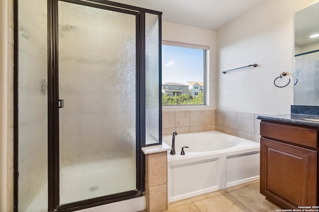 bathroom with vanity, independent shower and bath, and tile patterned flooring