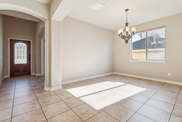 foyer entrance featuring a notable chandelier and light tile patterned floors