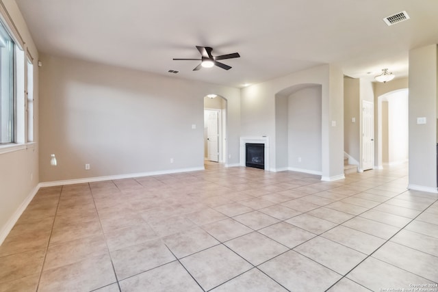 unfurnished living room featuring ceiling fan and light tile patterned floors