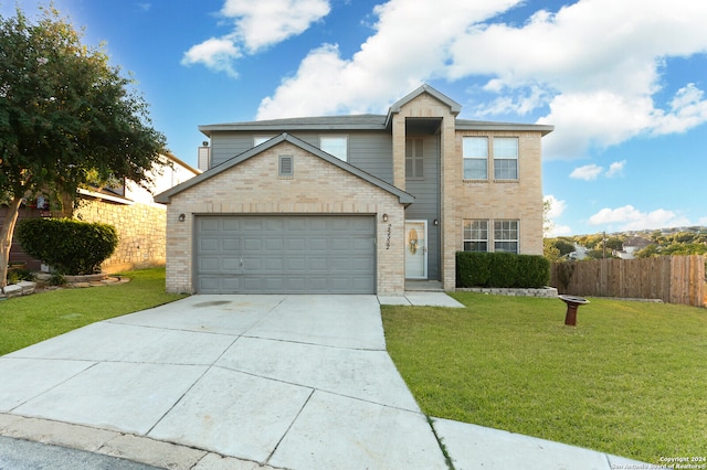 view of front of property with a garage and a front lawn