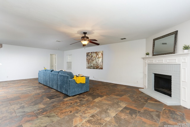 living room with a fireplace and ceiling fan