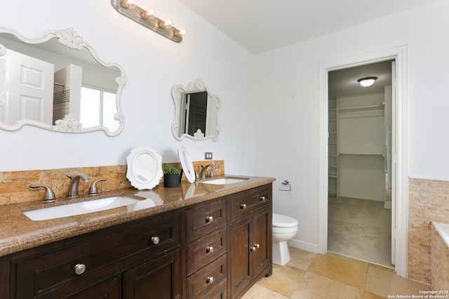 bathroom featuring a bathtub, vanity, and toilet