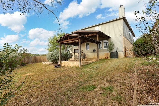 back of property featuring a patio, cooling unit, and a yard