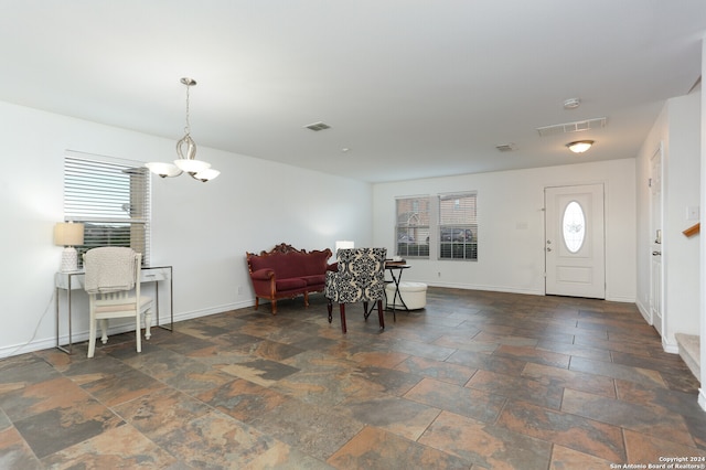 foyer entrance featuring an inviting chandelier