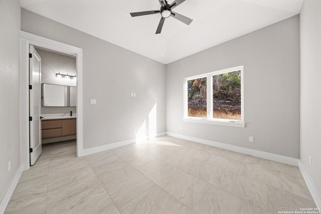 2920 Rocky Ridge Loop, Canyon Lake, TX 78133 - unfurnished bedroom featuring baseboards, connected bathroom, and ceiling fan