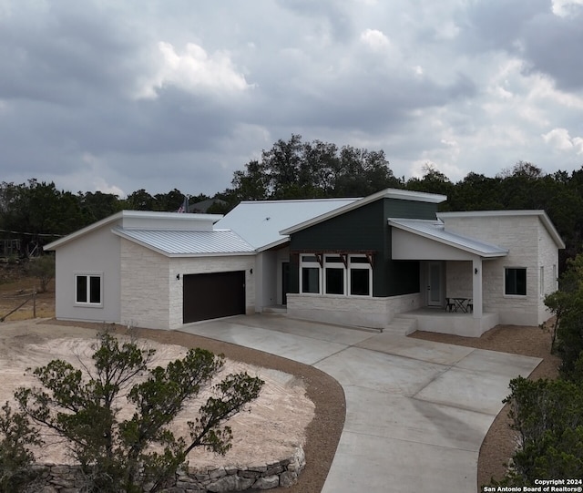 2920 Rocky Ridge Loop, Canyon Lake, TX 78133 - view of front of property featuring driveway, a garage, metal roof, and stone siding