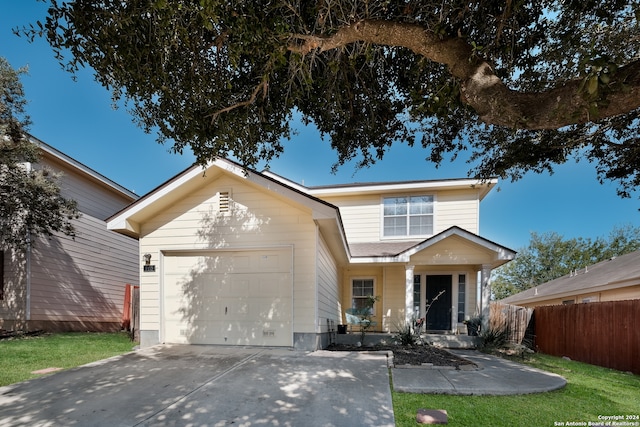 view of front of property featuring a garage and a front yard