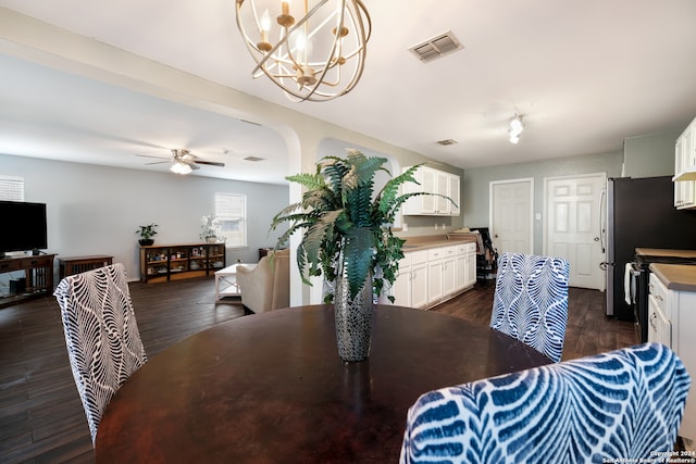 dining room featuring dark hardwood / wood-style floors and ceiling fan with notable chandelier