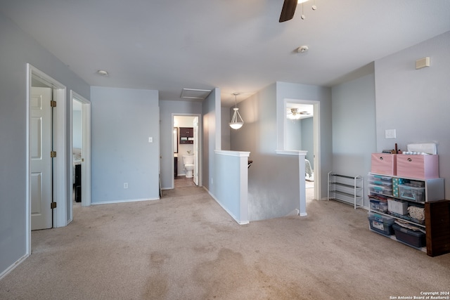 spare room with ceiling fan and light carpet