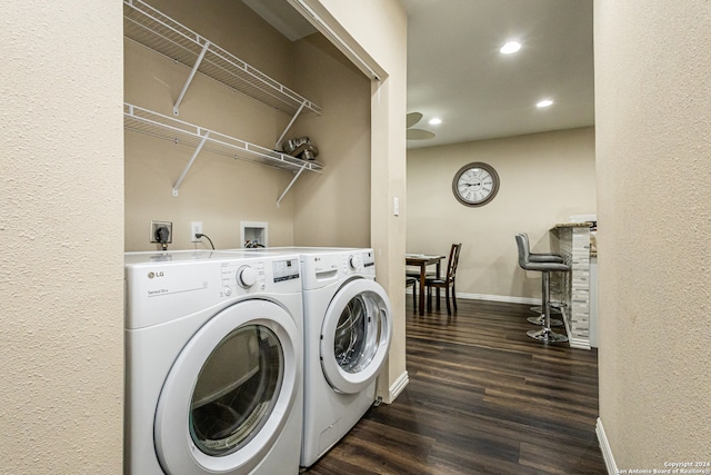 clothes washing area featuring washer and dryer and dark hardwood / wood-style floors