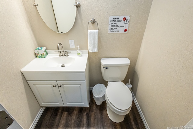 bathroom with hardwood / wood-style floors, vanity, and toilet