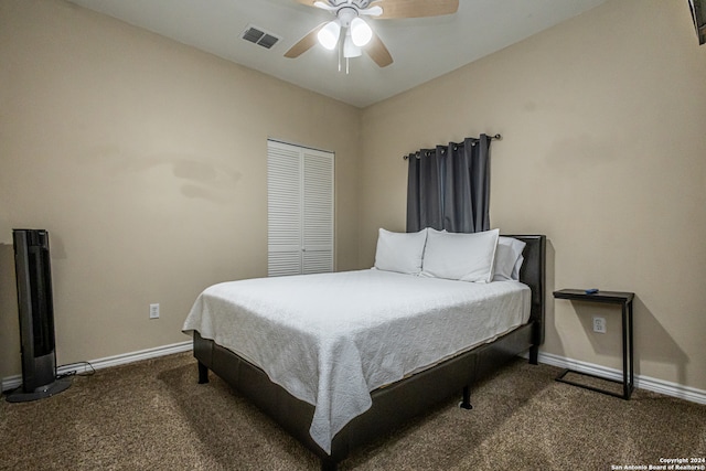 carpeted bedroom with ceiling fan and a closet