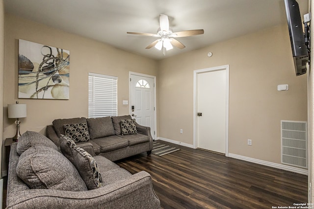 living room with ceiling fan and dark hardwood / wood-style flooring