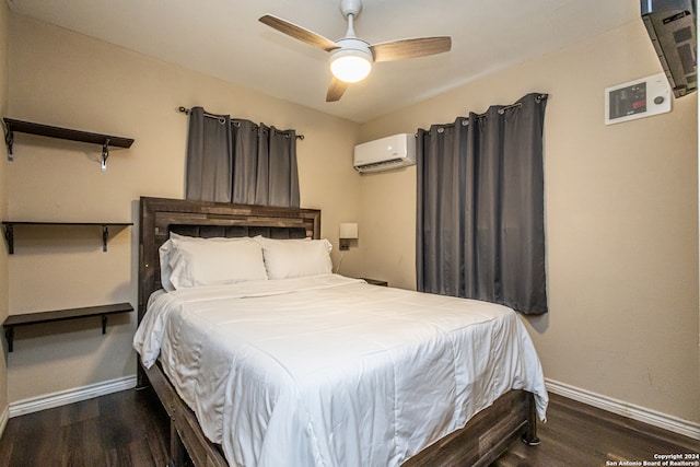 bedroom featuring ceiling fan, dark hardwood / wood-style floors, and an AC wall unit