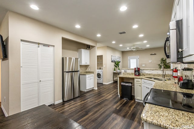 kitchen featuring sink, stainless steel appliances, washer / dryer, and white cabinets