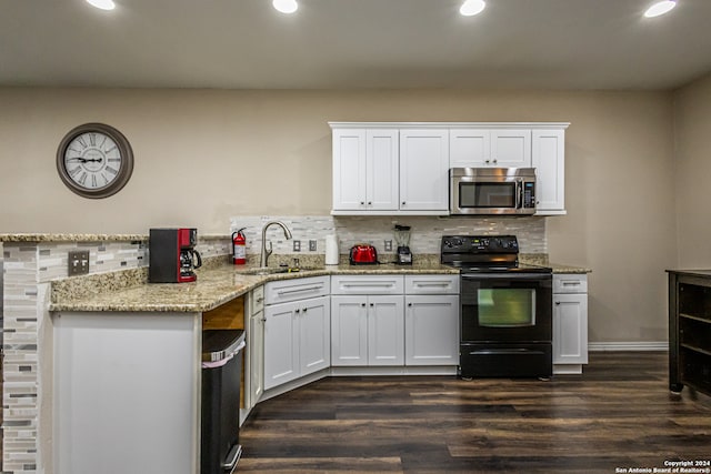 kitchen featuring white cabinetry, black electric range, and dark hardwood / wood-style flooring