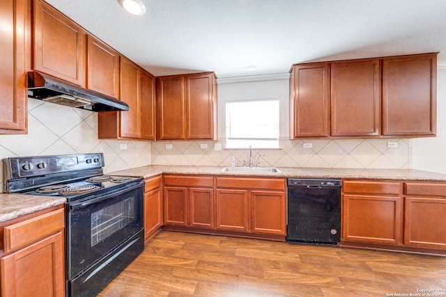 kitchen with sink, black appliances, backsplash, light hardwood / wood-style flooring, and crown molding