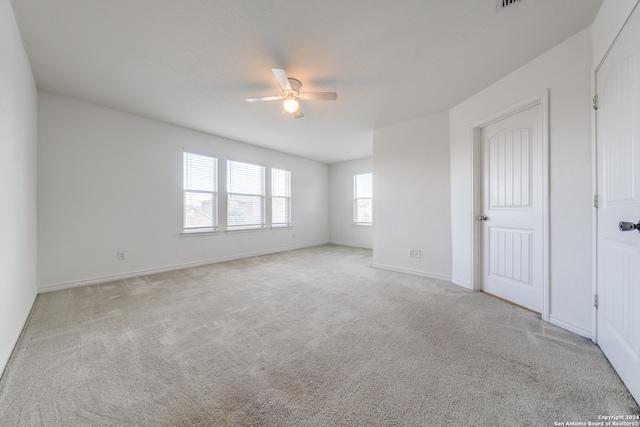 empty room with light carpet and ceiling fan