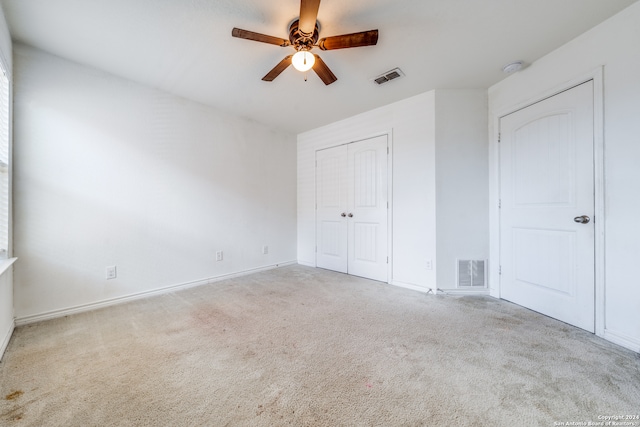 unfurnished bedroom featuring ceiling fan and light carpet