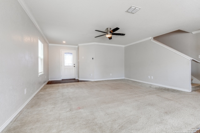 unfurnished living room with light colored carpet, ceiling fan, and ornamental molding