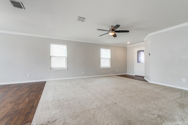 unfurnished room with dark wood-type flooring, ornamental molding, ceiling fan, and a healthy amount of sunlight