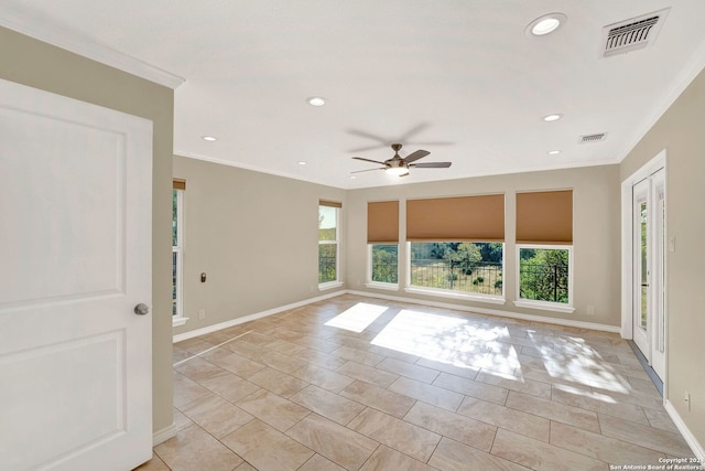 unfurnished room with ornamental molding, a wealth of natural light, light tile patterned floors, and ceiling fan