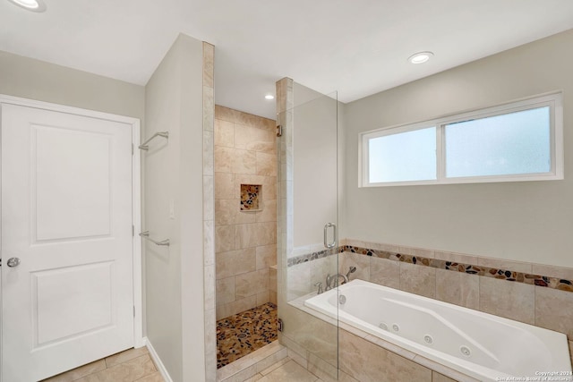 bathroom with tile patterned floors and shower with separate bathtub