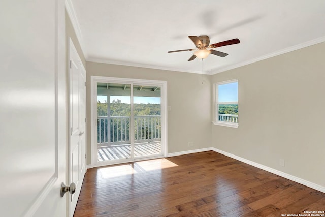 empty room with dark hardwood / wood-style flooring, ceiling fan, and crown molding