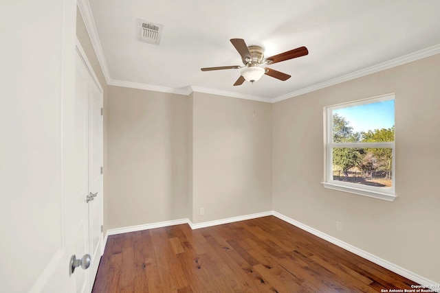 spare room with hardwood / wood-style floors, ceiling fan, and crown molding