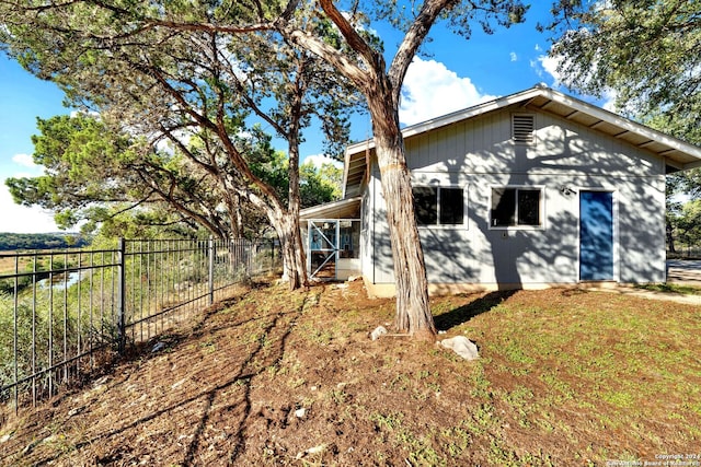 back of house featuring a lawn